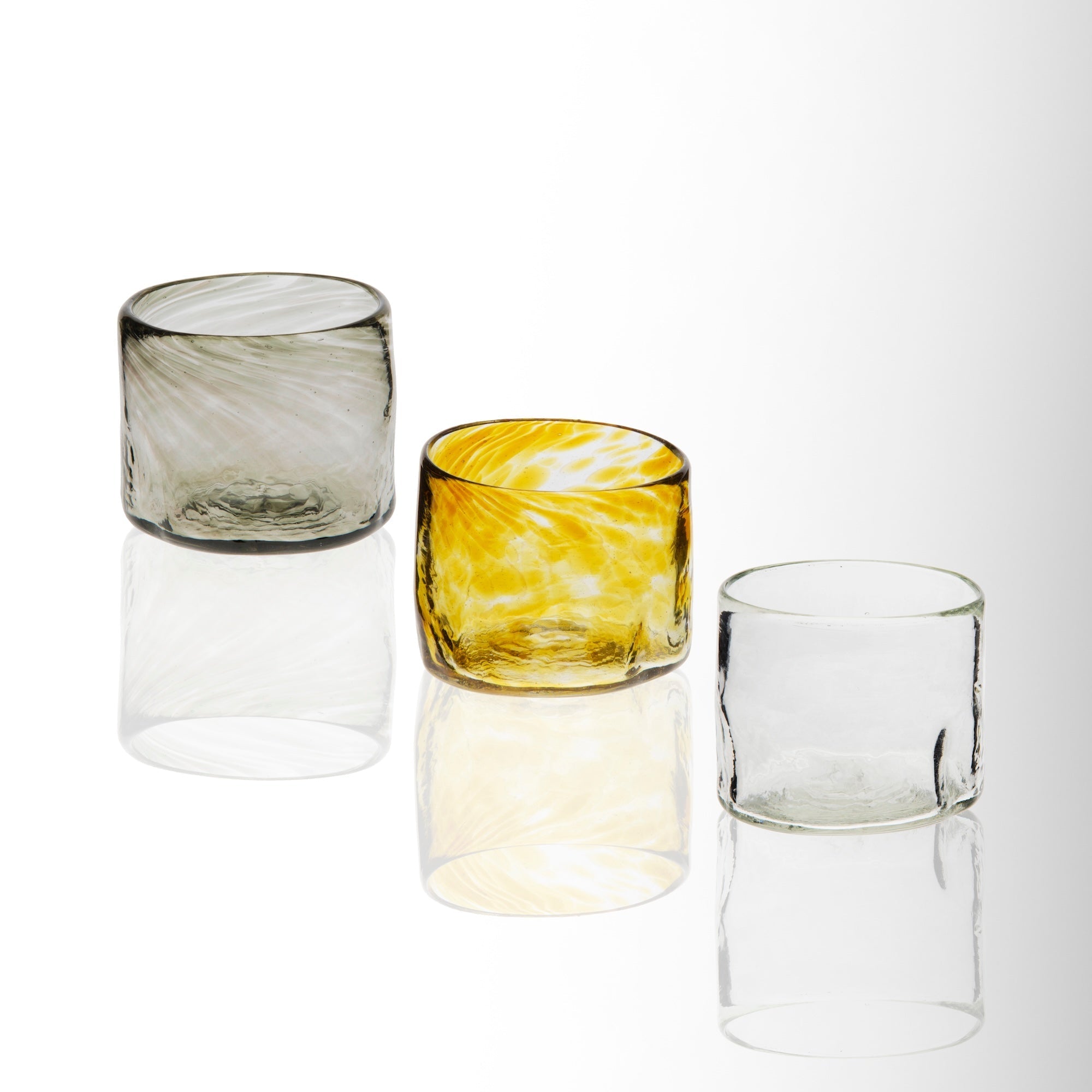 Three glass tumblers on a white background