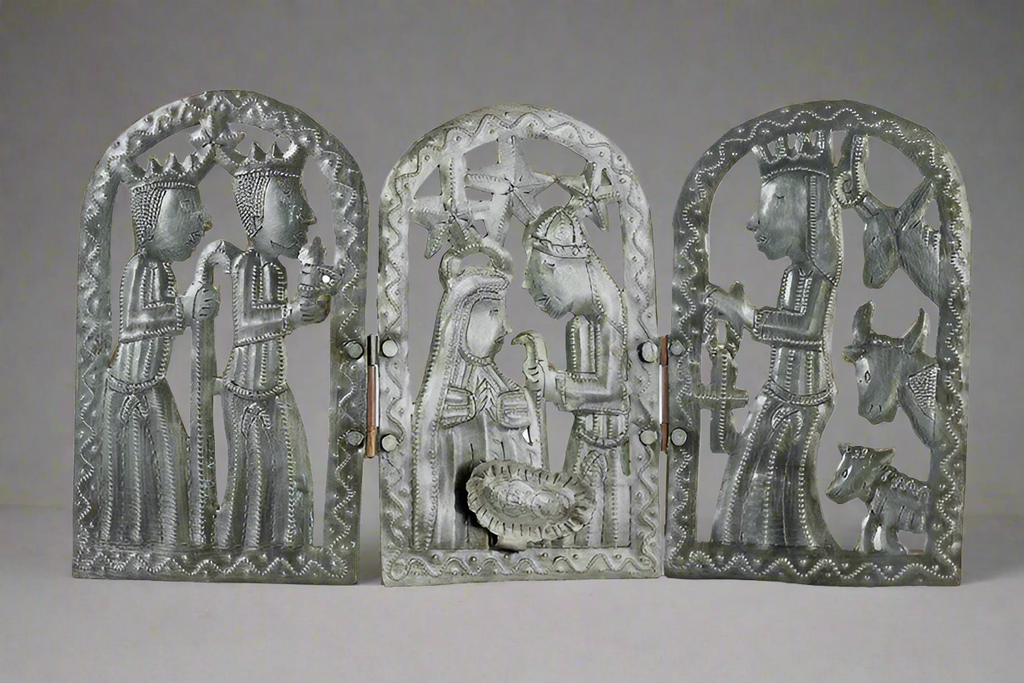 Three metal carvings of religious figures and animals on a gray background