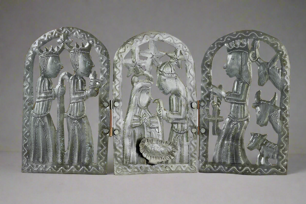 Three metal carvings of religious figures and animals on a gray background