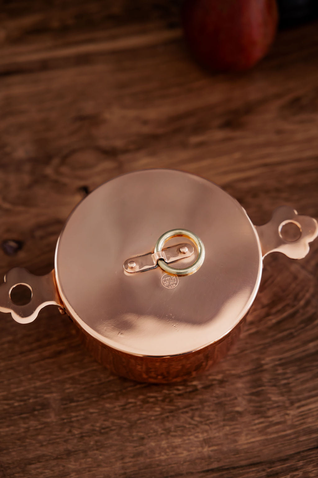 Copper pot on a wooden surface