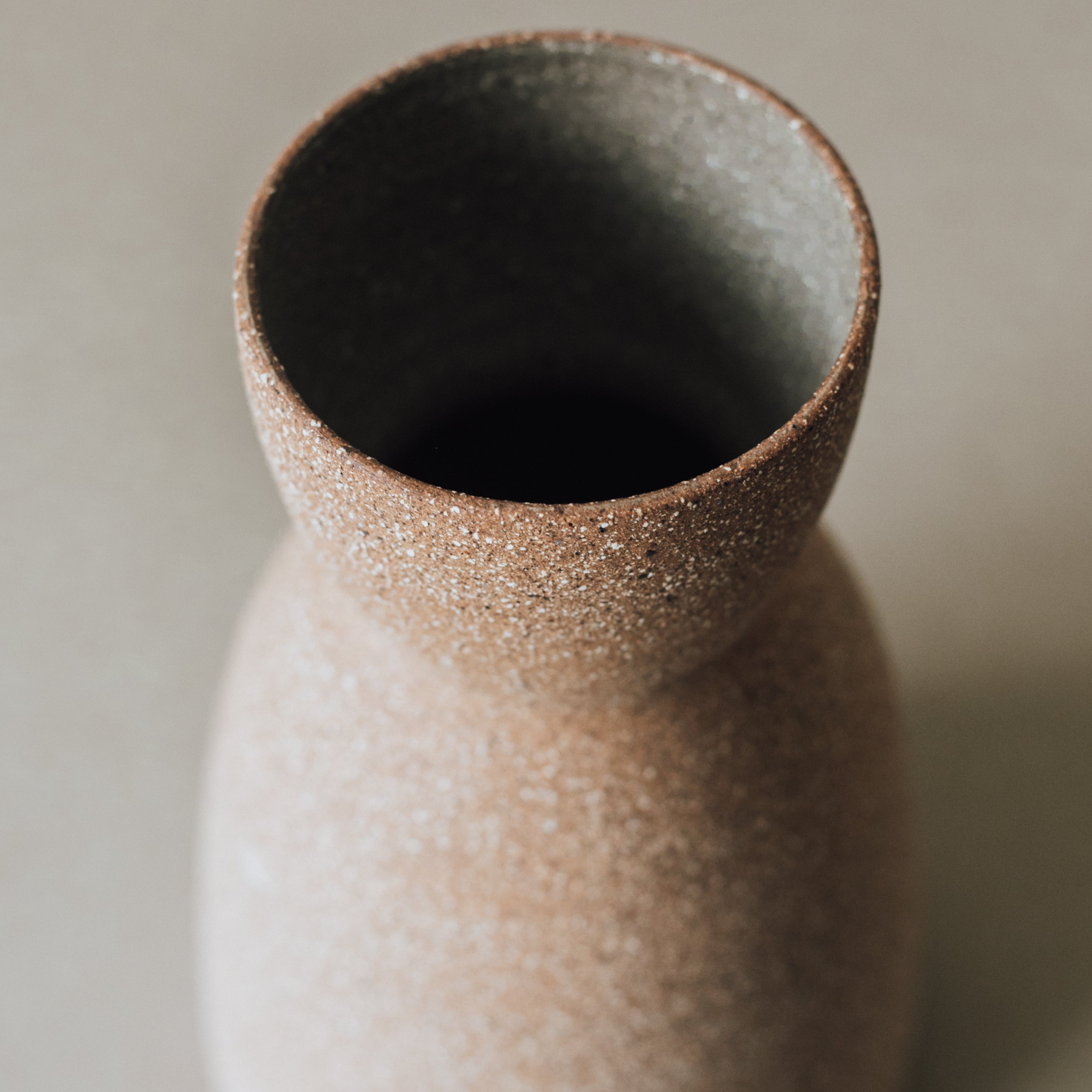 Textured ceramic vase on a neutral background