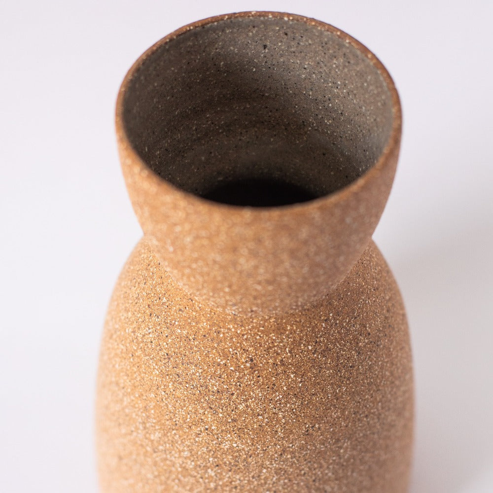 Brown textured vase on a white background