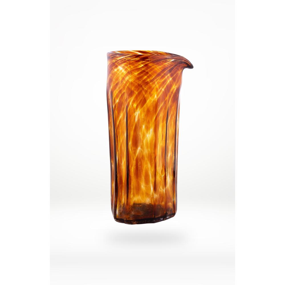 Decorative glass pitcher/vase with brown and orange swirl pattern on a white background