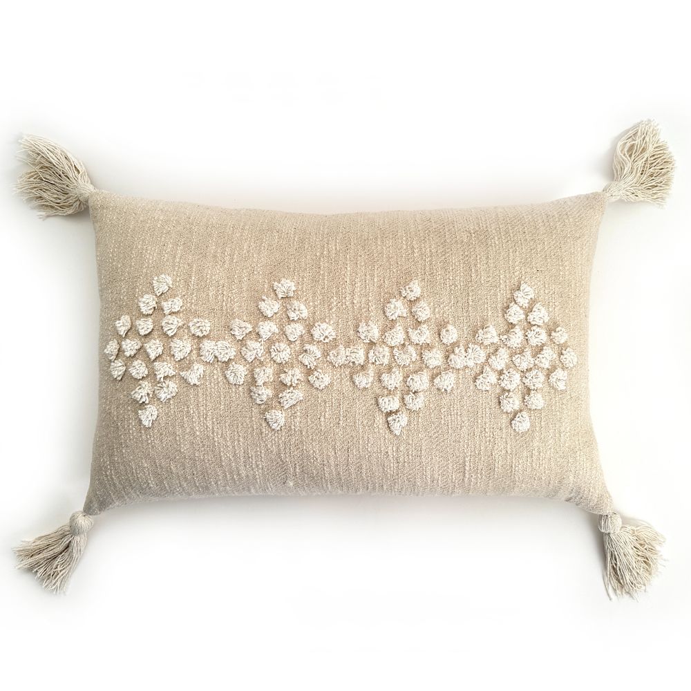 Decorative pillow with bead patterns and tassels on a white background