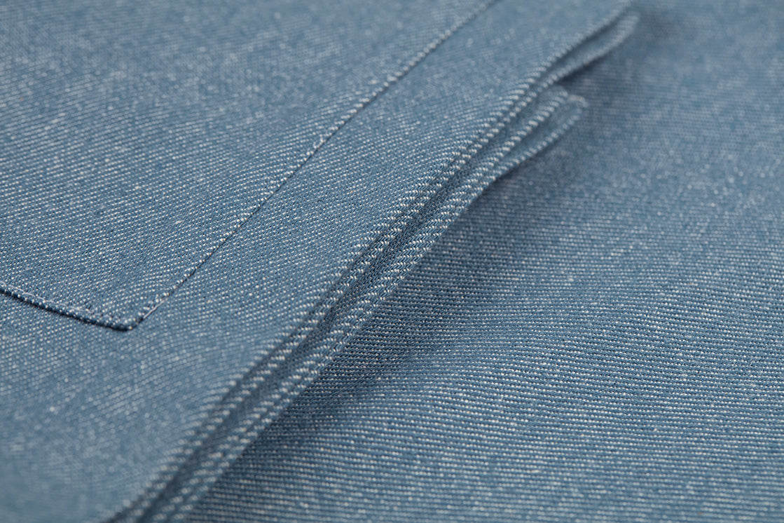 Close-up of blue denim cloth fabric napkin with stitching detail