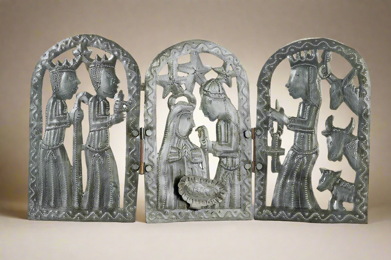 Decorative metal wall art with religious figures on a beige background