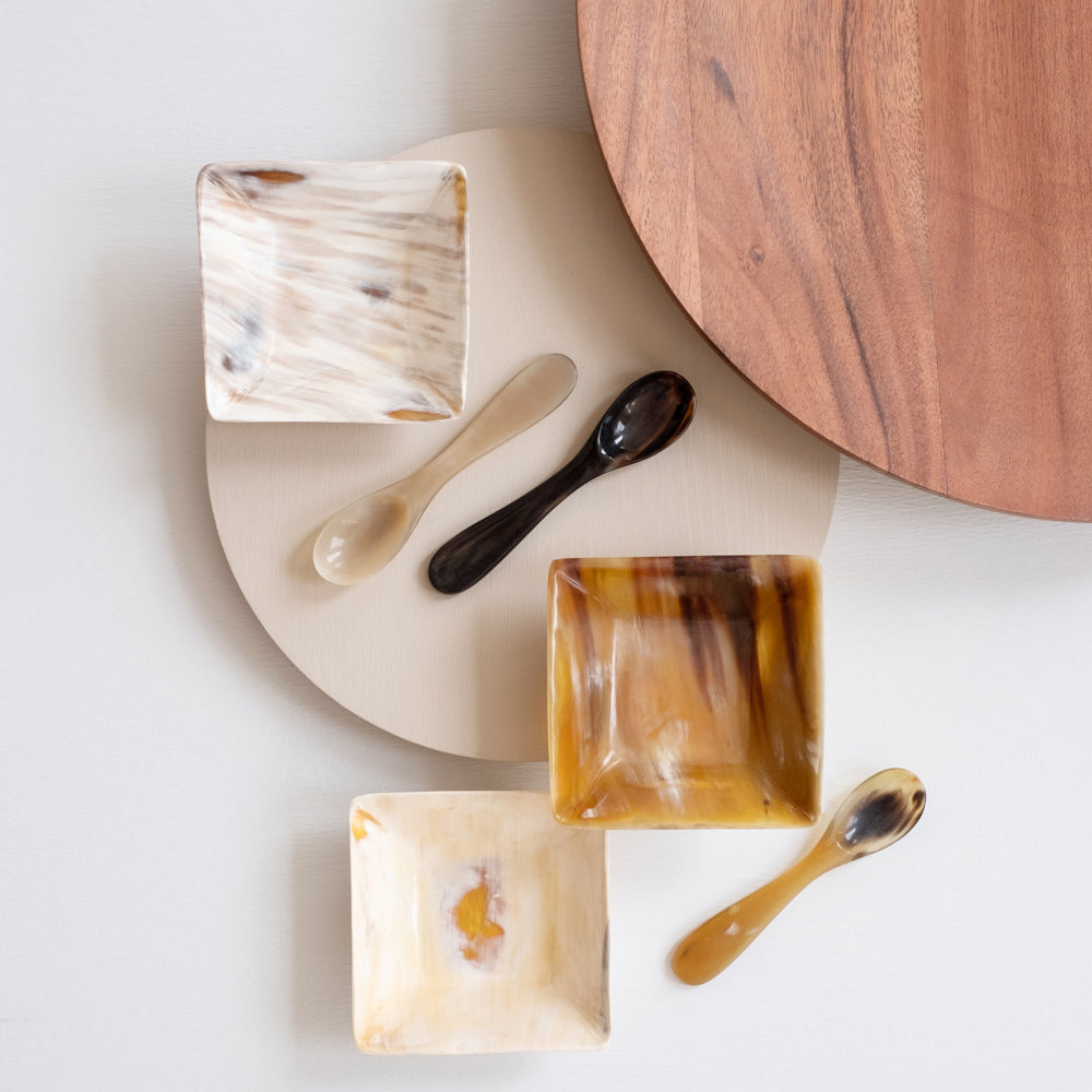 Set of seanson bowls and spoons on a white surface