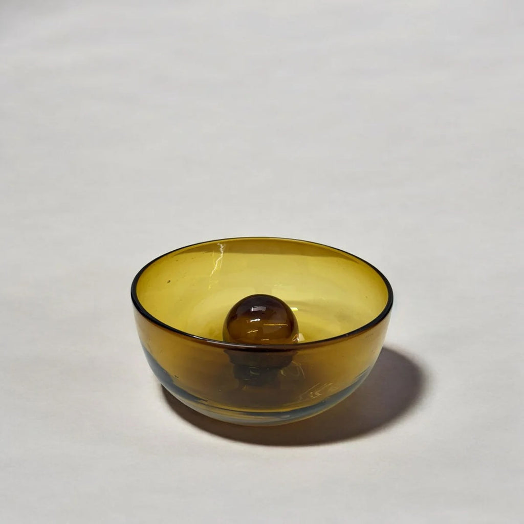 Yellow glass bowl on a white background
