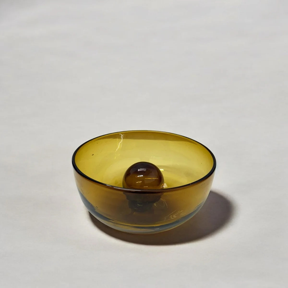 Yellow glass bowl on a white background