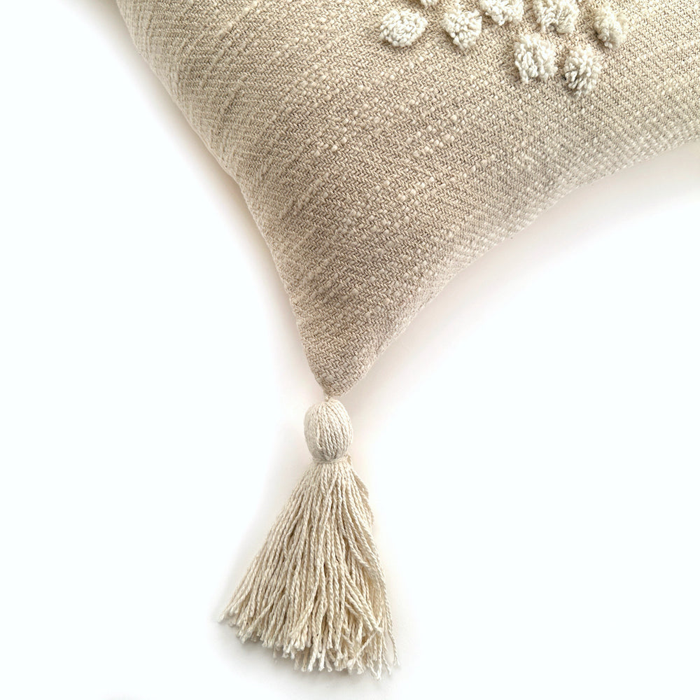 Textured pillow with tassels on a white background