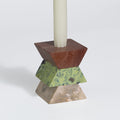 Geometric candle holder with a brown and green design on a white background