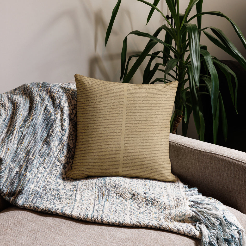 Luxury Comfort Pillow with a textured beige cover resting on a cozy patterned throw blanket on a neutral sofa, next to a tall green indoor plant, creating an elegant and inviting home decor setting.