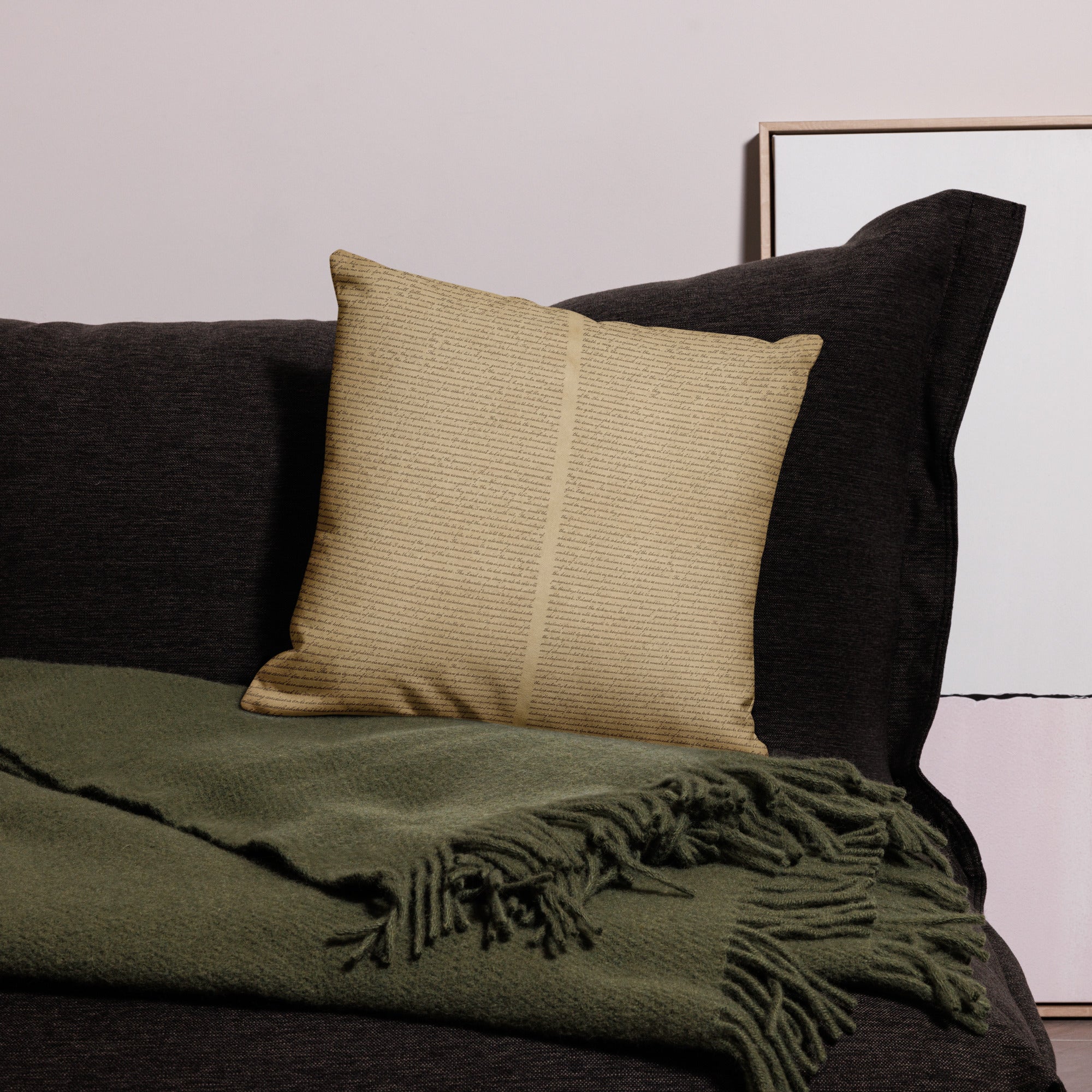 Luxury Comfort Pillow in a neutral textured fabric resting on a dark sofa with a soft green fringed throw, creating an elegant and cozy luxury home decor setting.