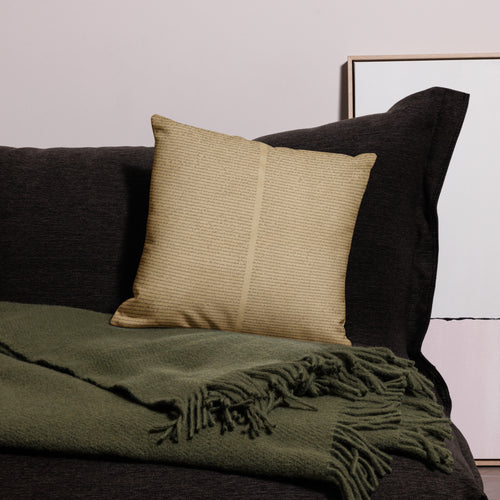 Luxury Comfort Pillow in a neutral textured fabric resting on a dark sofa with a soft green fringed throw, creating an elegant and cozy luxury home decor setting.
