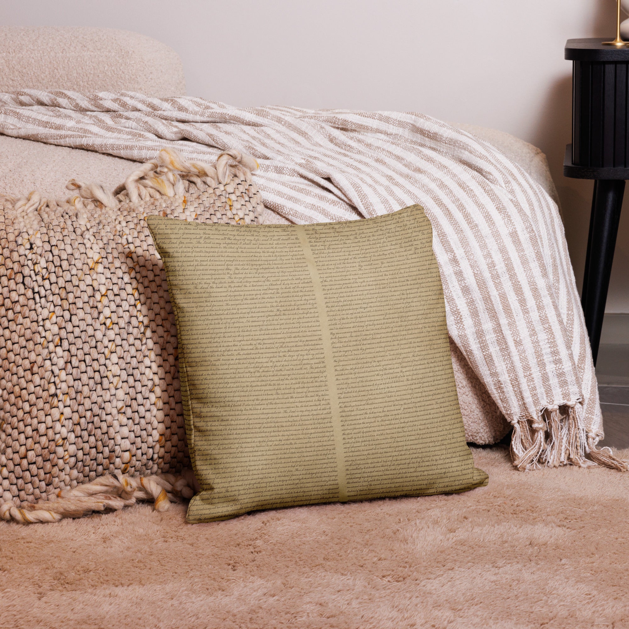 Luxury Comfort Pillow in a soft, textured olive green fabric placed on a beige shaggy rug next to woven and striped neutral-toned throws in a cozy home decor setting.