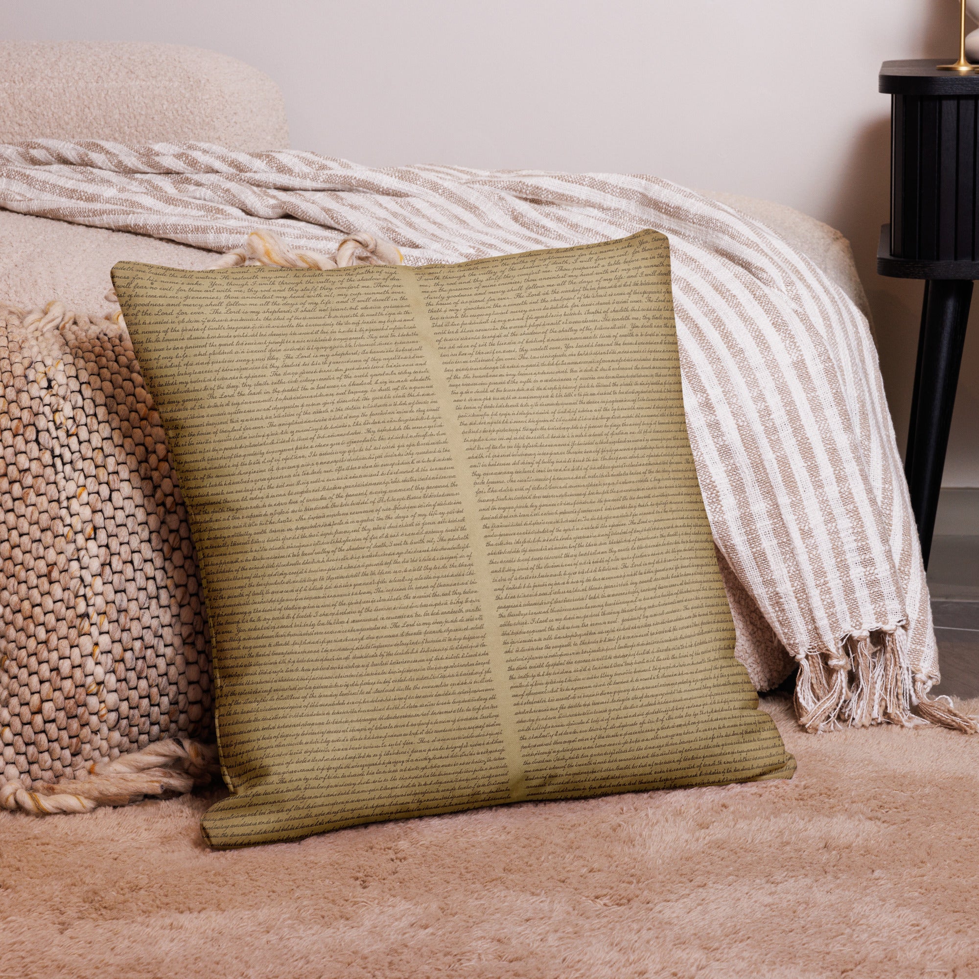 Luxury Comfort Pillow with a subtle textured pattern in warm beige, placed on a soft carpet alongside cozy knit and striped throws for an elegant home decor touch.
