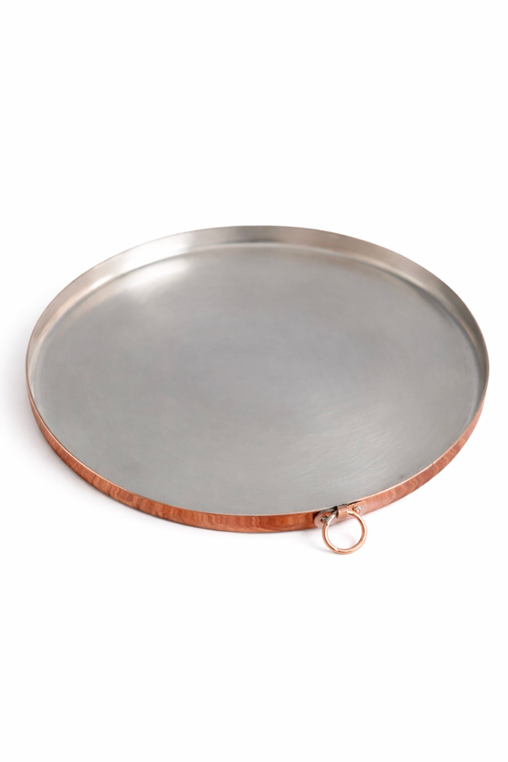 Round copper baking dish with copper rim on a white background