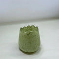 Green textured glass vase on a white background