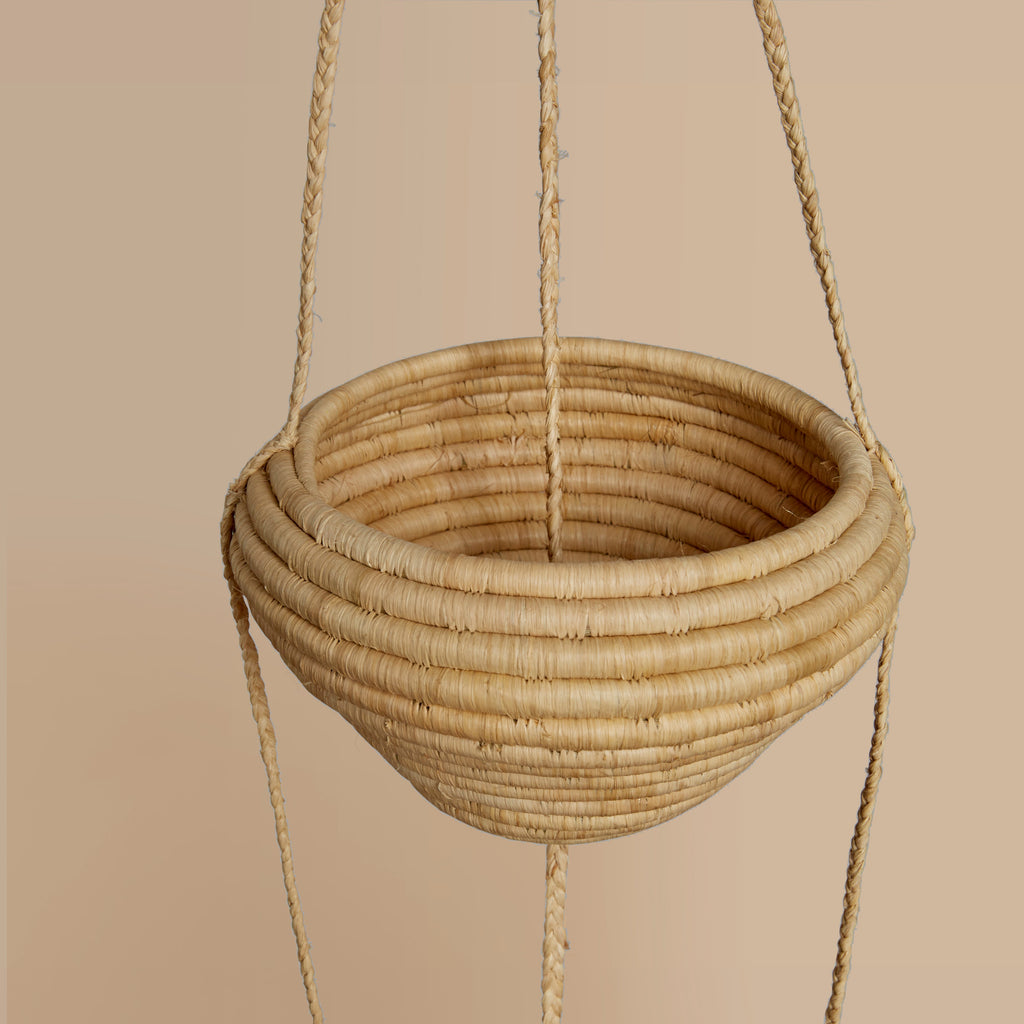 Hand Woven hanging basket on a beige background
