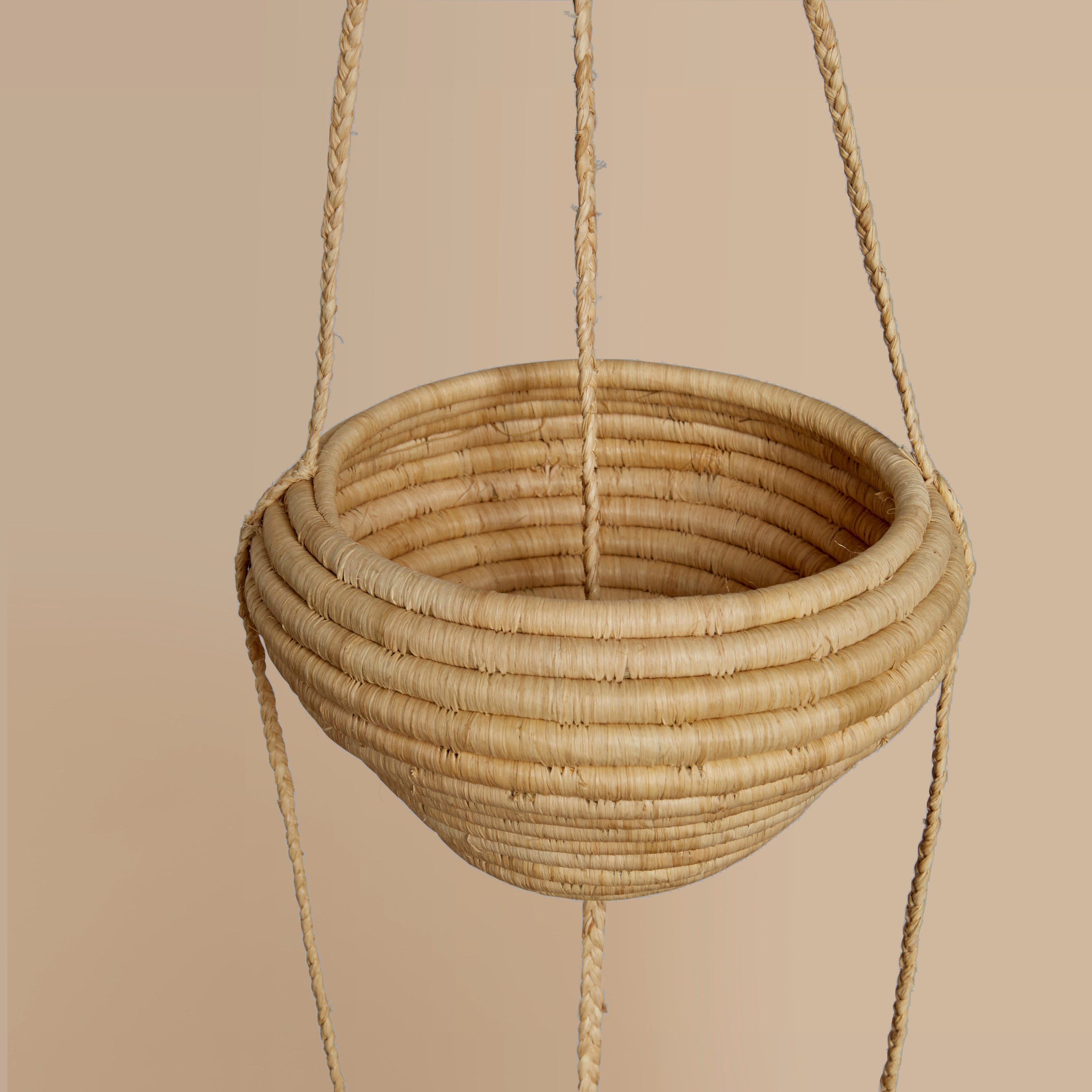 Hand Woven hanging basket on a beige background