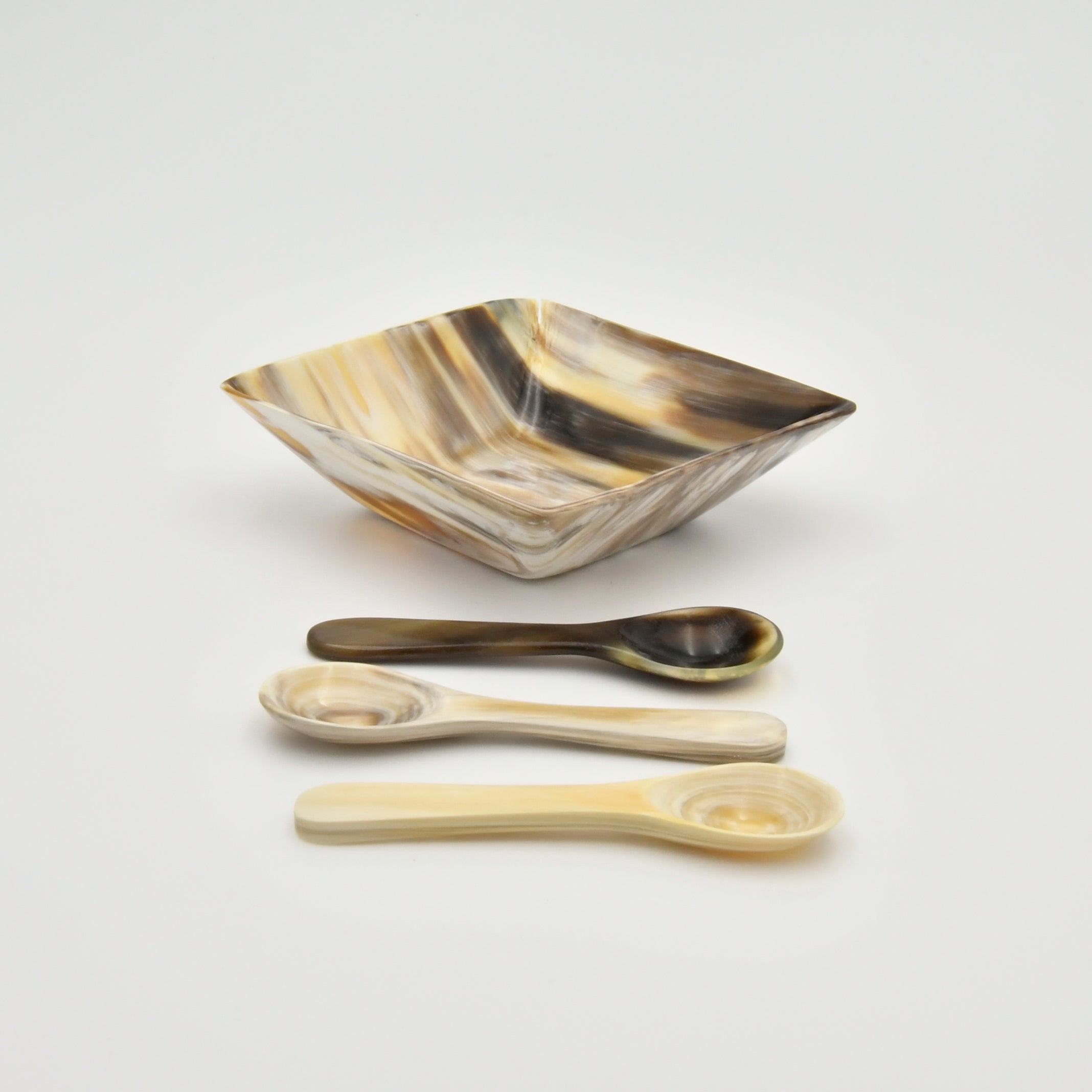 Decorative bowl and spoons on a light gray background
