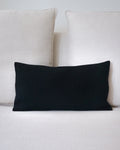 Black pillow on a light-colored sofa