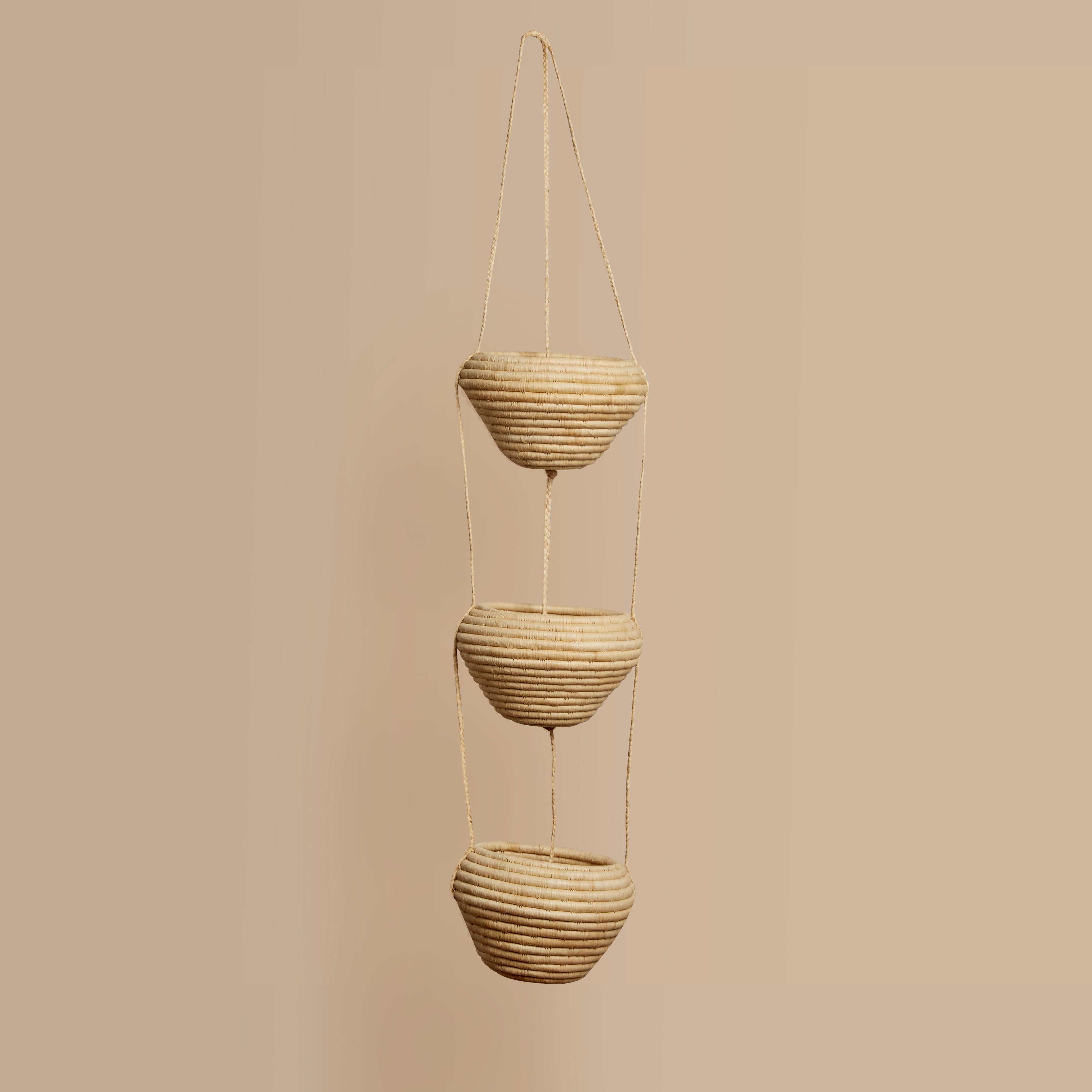 3 Tiered Hanging  hand woven planters on a beige background