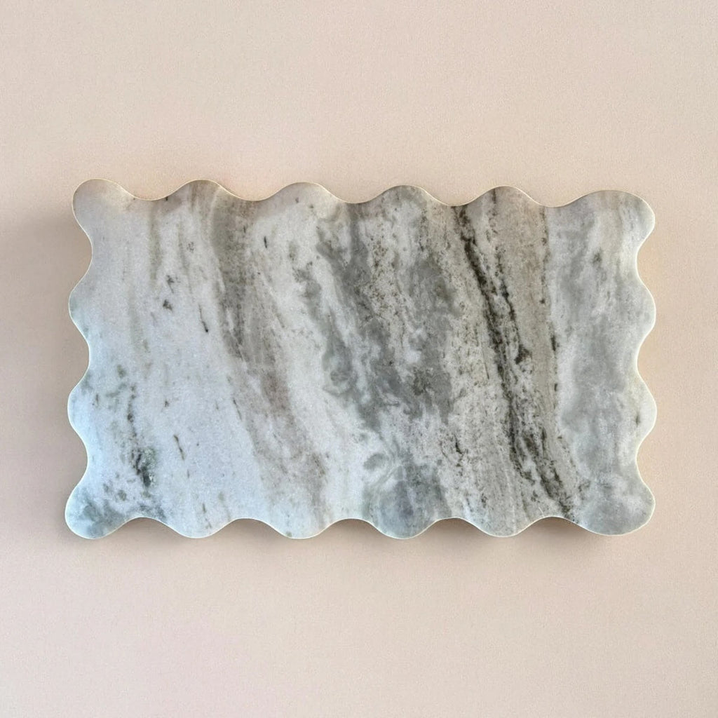 Marble Cutting Board with wavy edge on a beige background