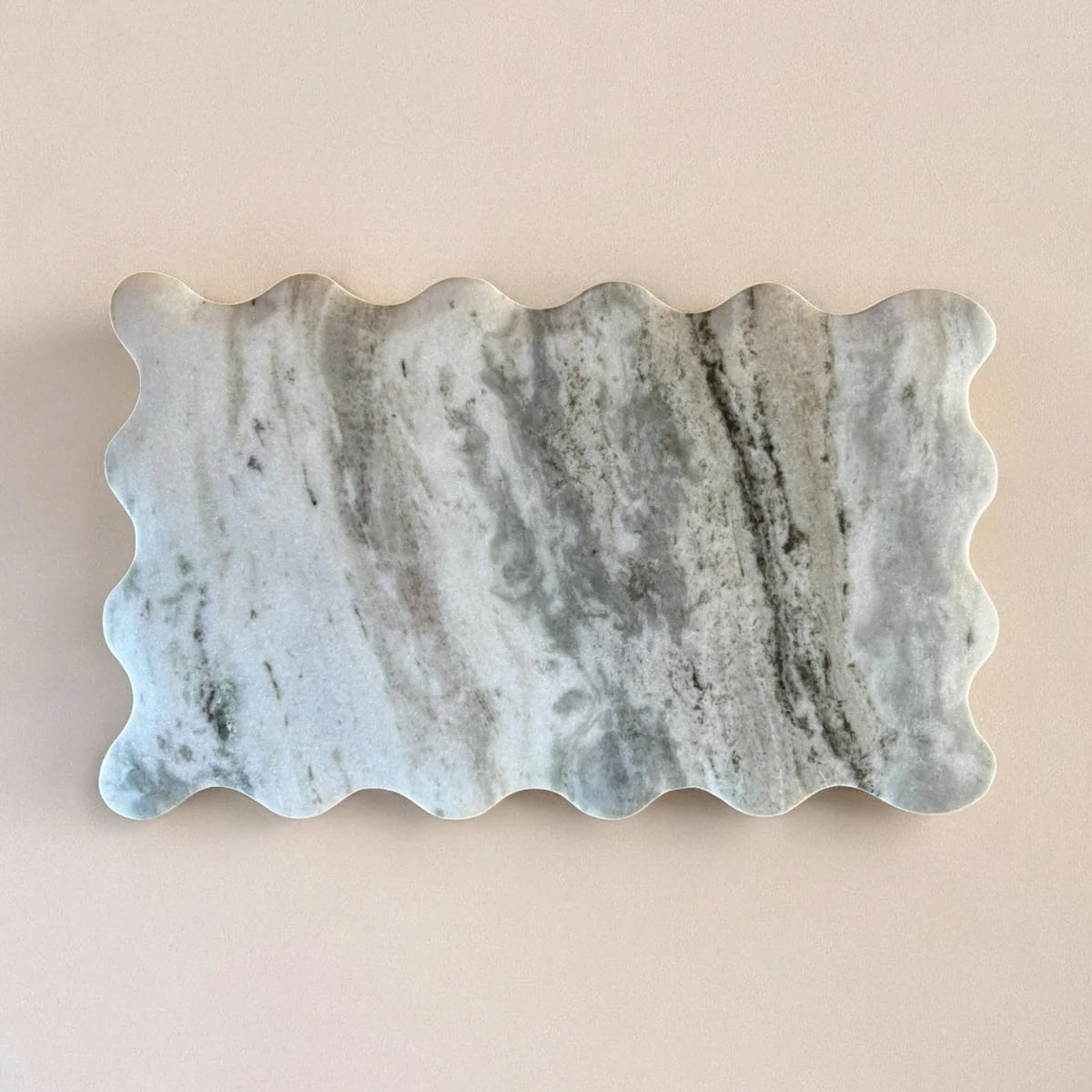 Marble Cutting Board with wavy edge on a beige background