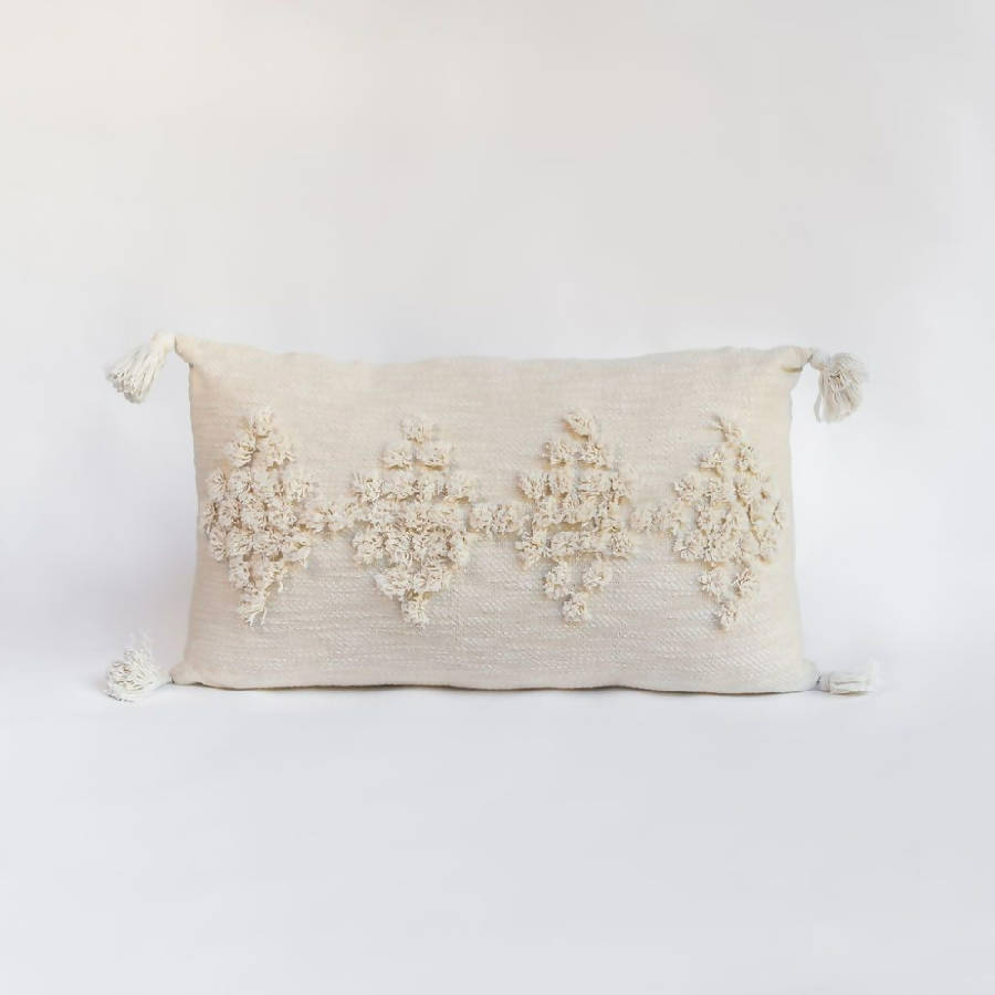 Decorative pillow with floral embroidery on a white background