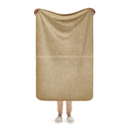 Person holding a tan Luxury Sherpa Throw Blanket featuring a subtle striped texture, showcasing its soft and cozy fabric ideal for premium home decor.