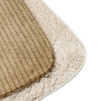 Close-up of a tan Luxury Sherpa Throw Blanket showing a soft, plush sherpa side and a smooth side with cursive script pattern, highlighting its premium, elegant texture.