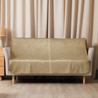 Luxury Sherpa Throw Blanket in tan color draped over a modern beige sofa in a cozy living room setting with wood flooring and light curtains.