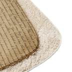 Close-up view of a tan Luxury Sherpa Throw Blanket featuring a soft, fluffy sherpa side and a patterned fabric side with printed script text for an elegant touch.